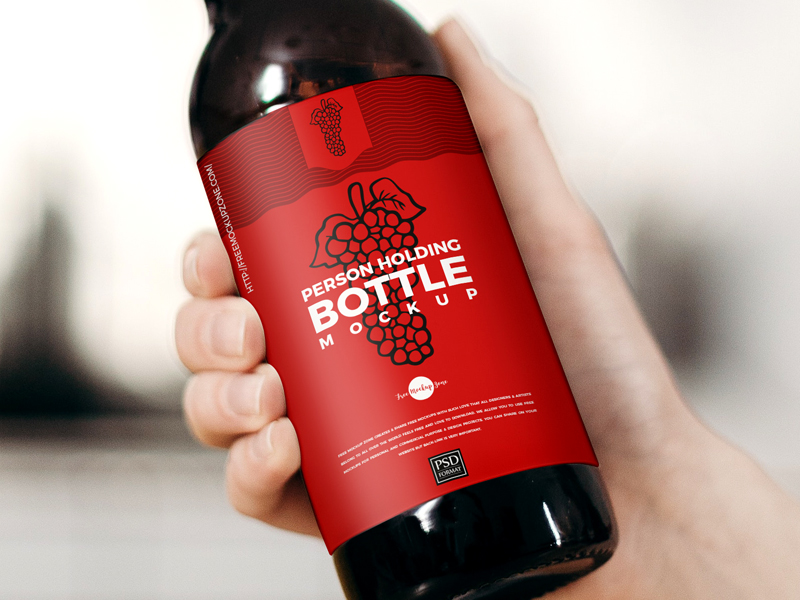 Free-Person-Holding-Bottle-Mockup-600