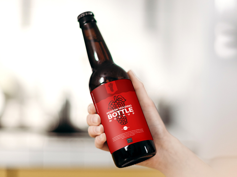 Free-Person-Holding-Bottle-Mockup