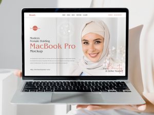 Free-Modern-Female-Holding-MacBook-Pro-Mockup-600