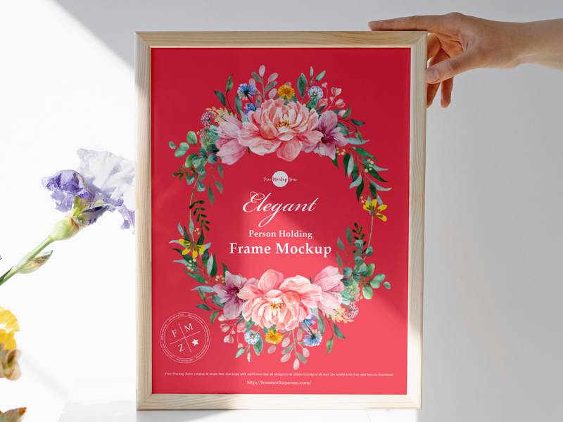 Free-Elegant-Person-Holding-Frame-Mockup-600