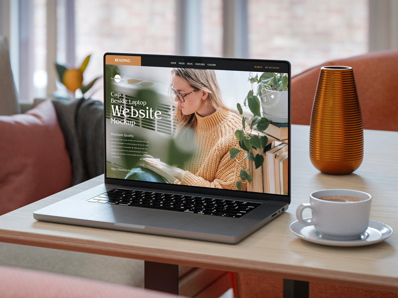 Free-Cup-Beside-Laptop-Website-Mockup