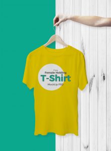 Free-Cool-Female-Holding-T-Shirt-Mockup-For-Branding