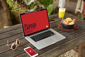 Free-Smartphone-With-Laptop-Mockup-Placing-on-Wooden-Table