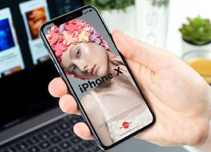 Free-Man-Holding-in-Hand-iPhone-X-Mockup-PSD-300