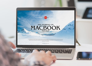Free-Man-Working-on-MacBook-Mockup-300
