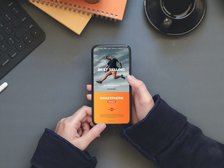 Free Workstation Person Holding Smartphone Mockup Free