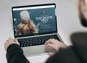 Free-Person-Working-on-MacBook-Pro-Mockup-300