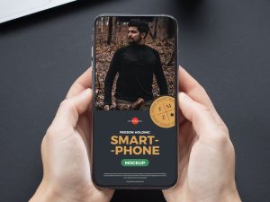 Free-Elegant-Person-Holding-Smartphone-Mockup-600